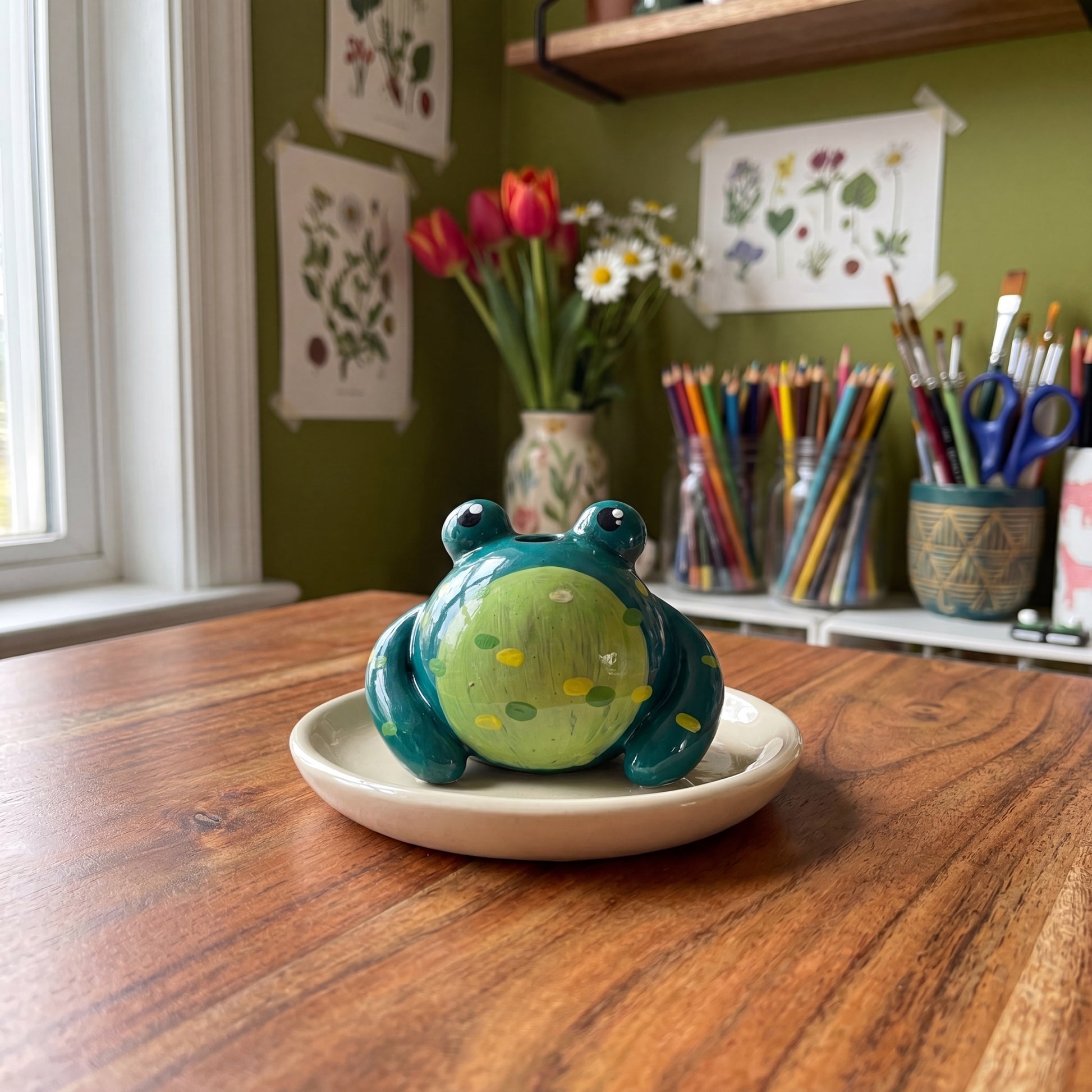 Mr. Ribbit handmade glossy clay desk pal, styled in the Moon Kiln studio, daytime
