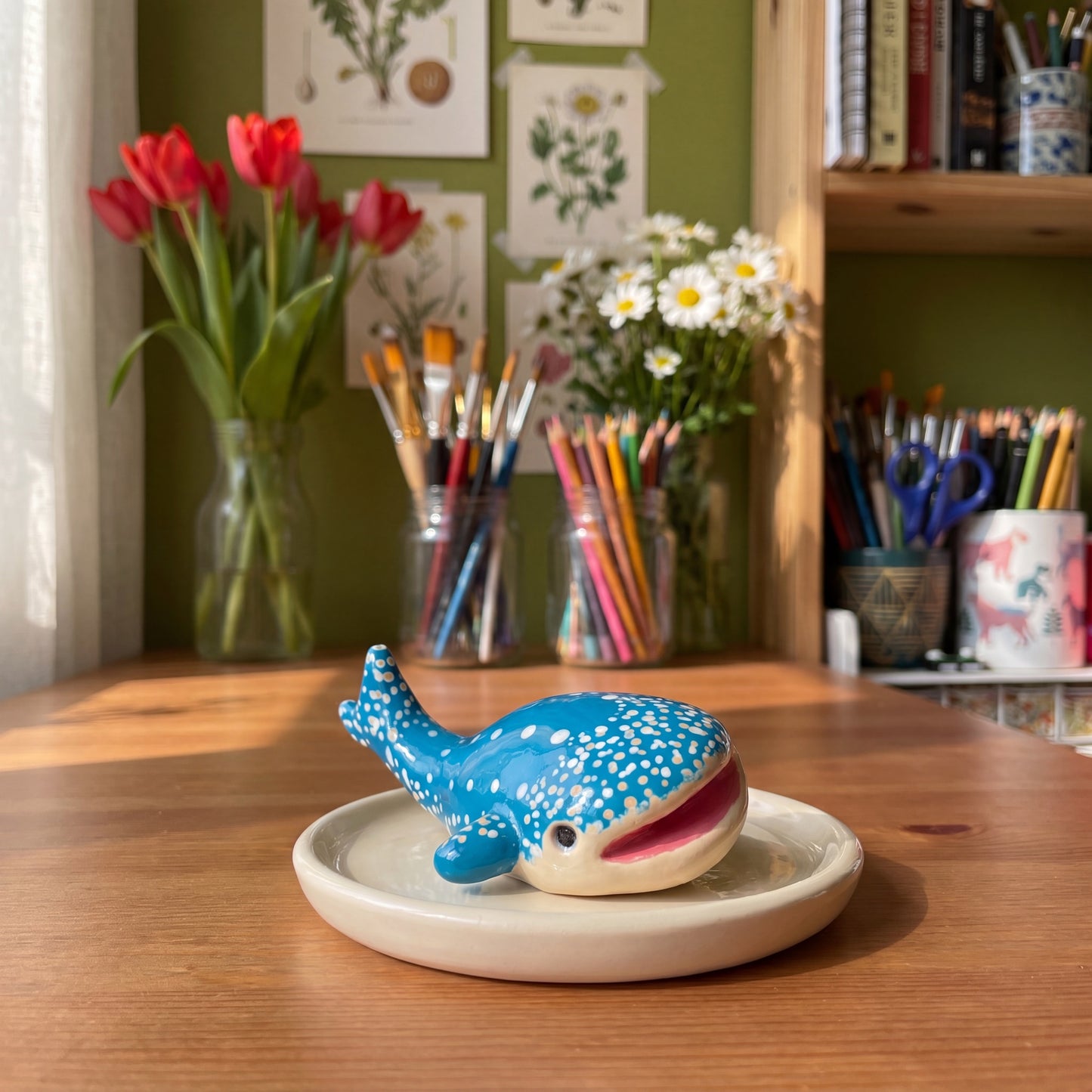 Happy Whale handmade glossy clay desk pal, styled in the Moon Kiln studio, daytime