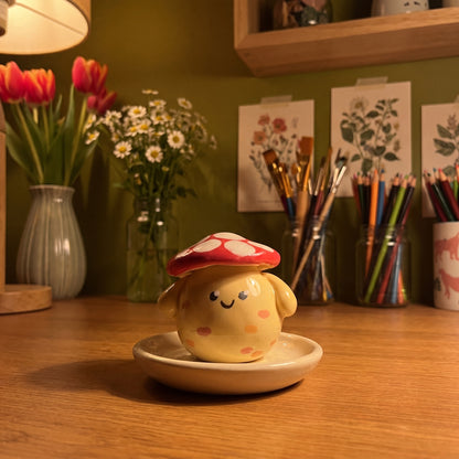 Mushroom Pal handmade glossy clay desk pal, in the Moon Kiln studio, evening lamp light