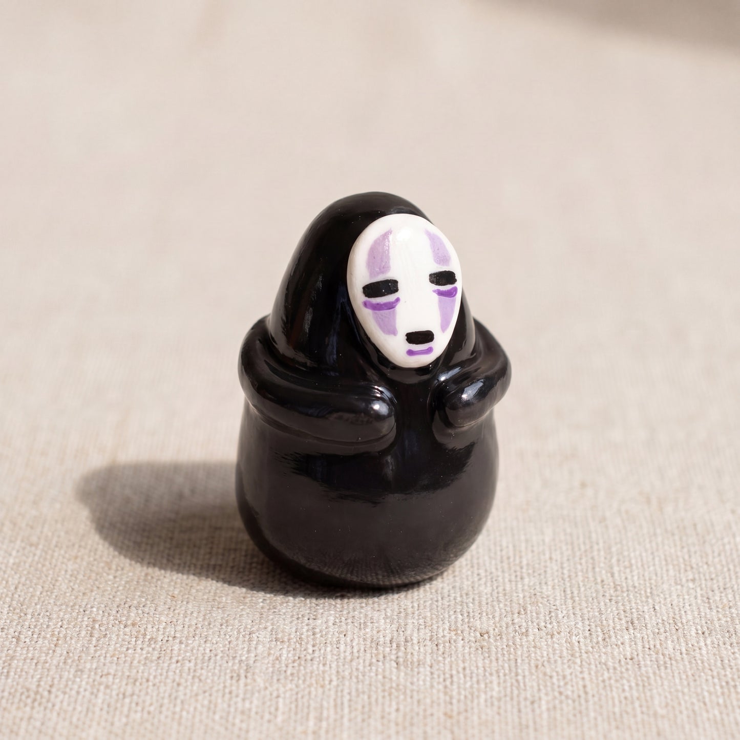 Masked Spirit handmade glossy clay desk pal, front view