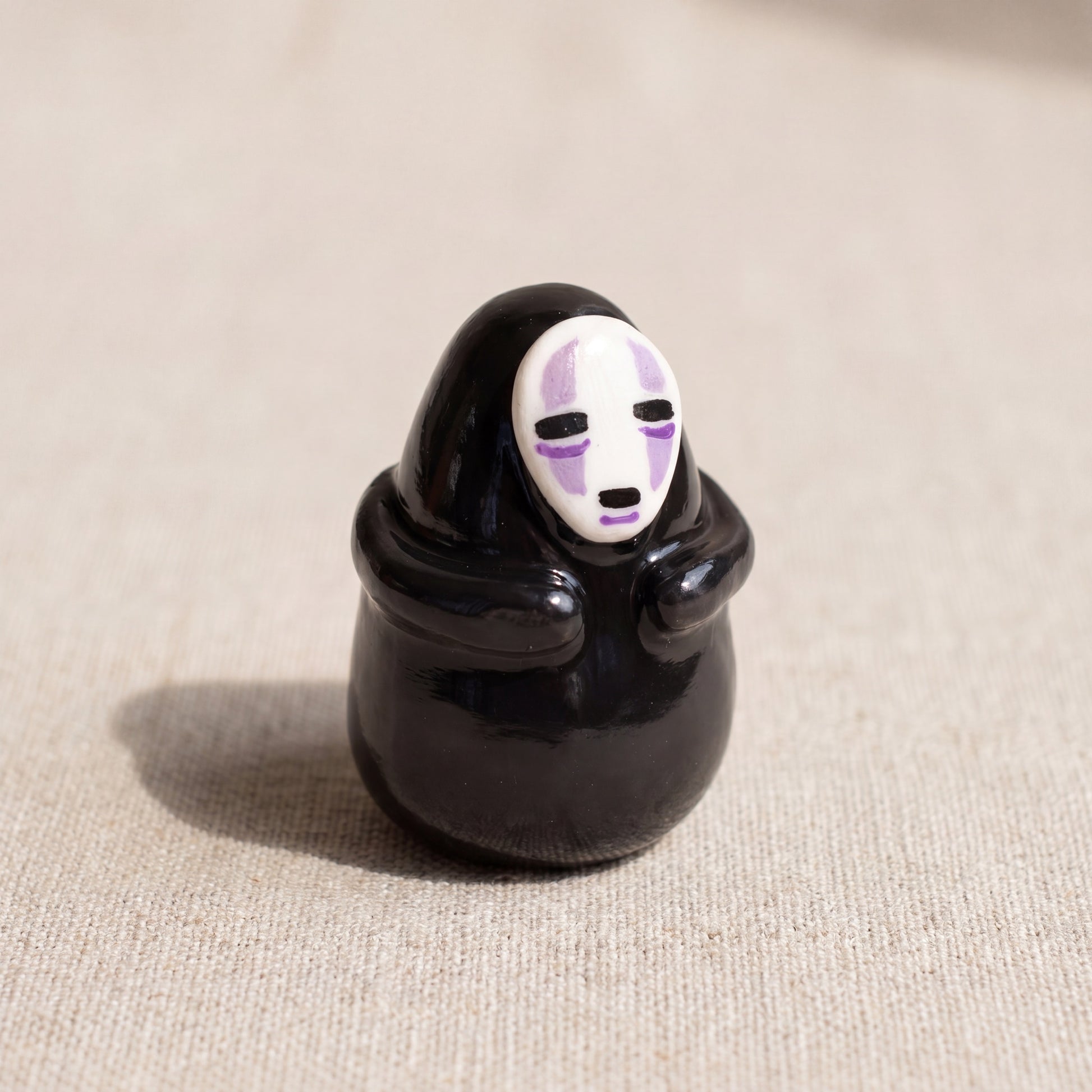Masked Spirit handmade glossy clay desk pal, front view