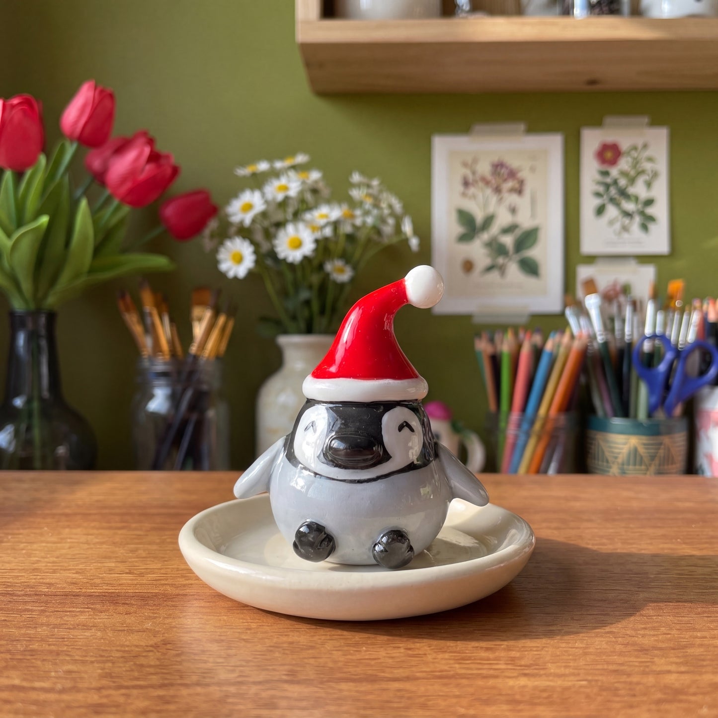 Baby Pingoo handmade glossy clay desk pal, styled in the Moon Kiln studio, daytime