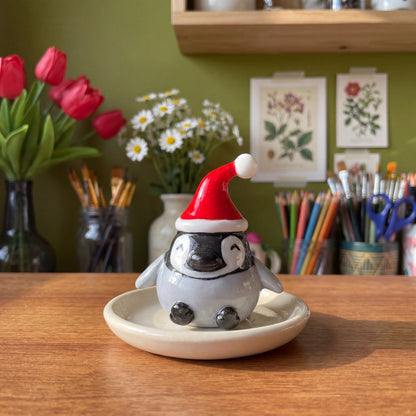 Baby Pingoo handmade glossy clay desk pal, styled in the Moon Kiln studio, daytime