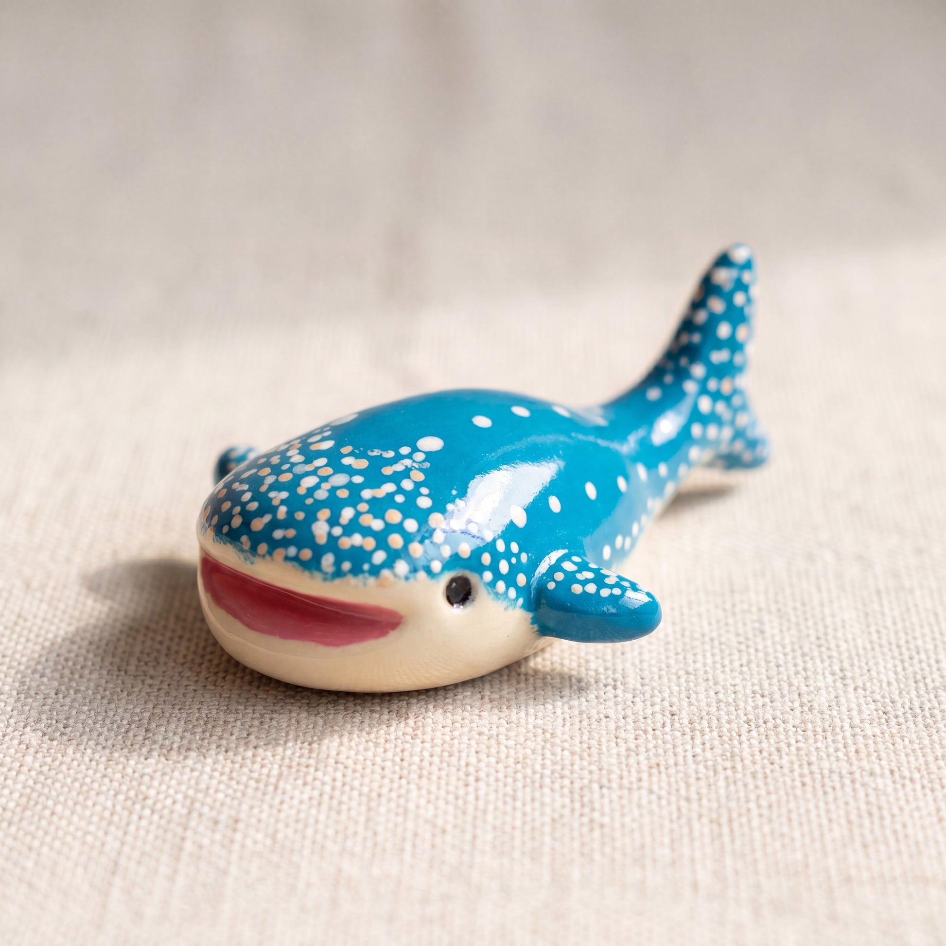 Happy Whale handmade glossy clay desk pal, front view