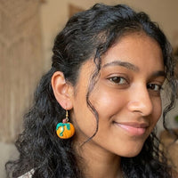 Pumpkiln handmade polymer-clay earrings, worn on the ear