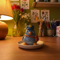Mailbert handmade glossy clay desk pal, in the Moon Kiln studio, evening lamp light