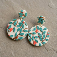 Teal Forest handmade polymer-clay earrings, the pair on a warm stone surface
