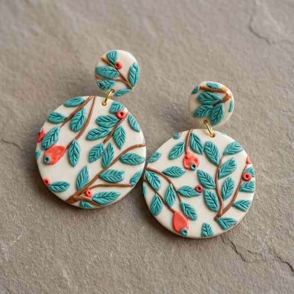 Teal Forest handmade polymer-clay earrings, the pair on a warm stone surface