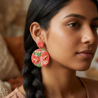 Hibiscus handmade polymer-clay earrings, worn on the ear