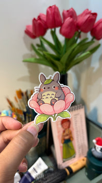 Forest Spirit on a Flower vinyl sticker held in hand, angled view showing the die-cut white border